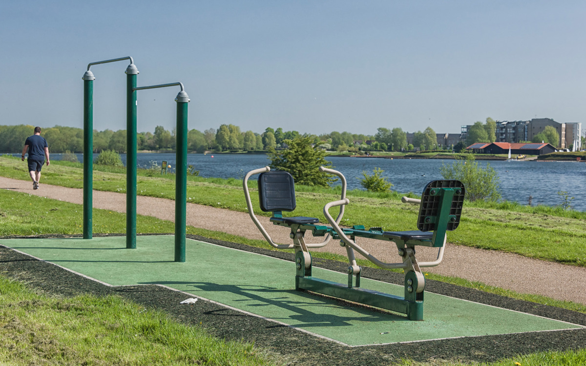 Outdoor gym equipment at lakeside.