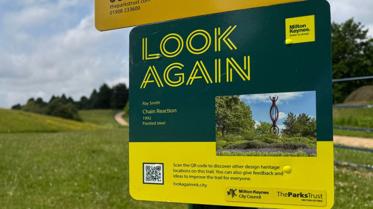 Look Again trail sign with grass in background
